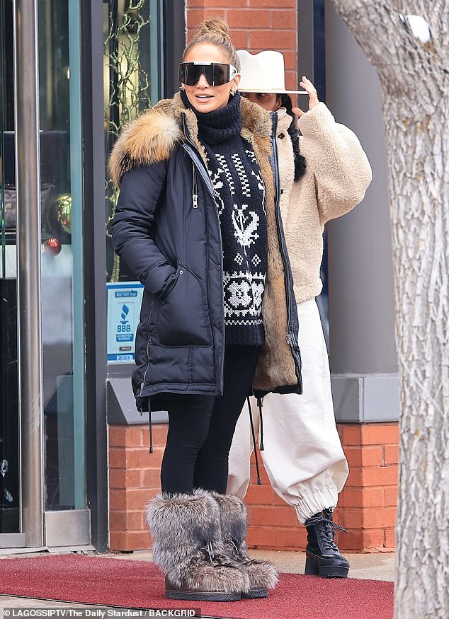 She paired her look with leggings, furry boots and designer sunglasses while wearing her honey-toned locks up in a bun.