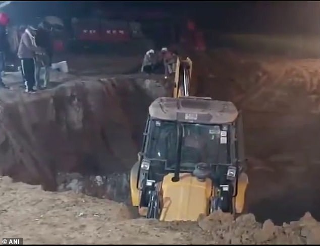 Distressing footage shows an excavator tunneling into the shaft as emergency workers wait patiently beside it.