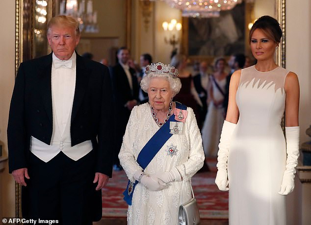 Donald Trump and US First Lady Melania Trump pose for a photo ahead of a state banquet in the ballroom of Buckingham Palace