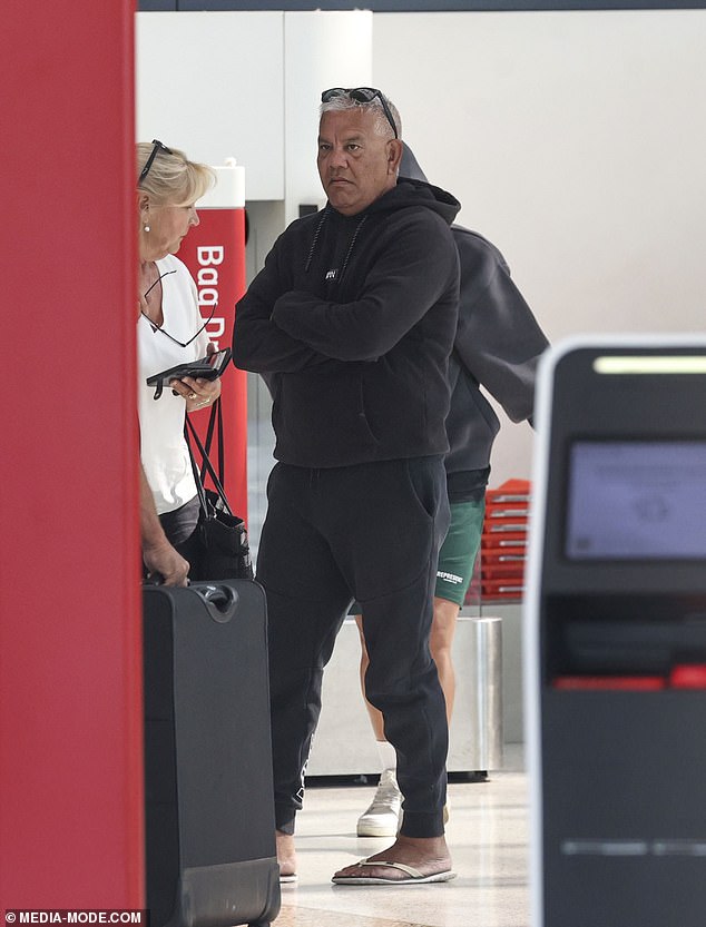 Sam's father Roger looked somber as he arrived at the airport with his family following his beloved mother's hospitalization.