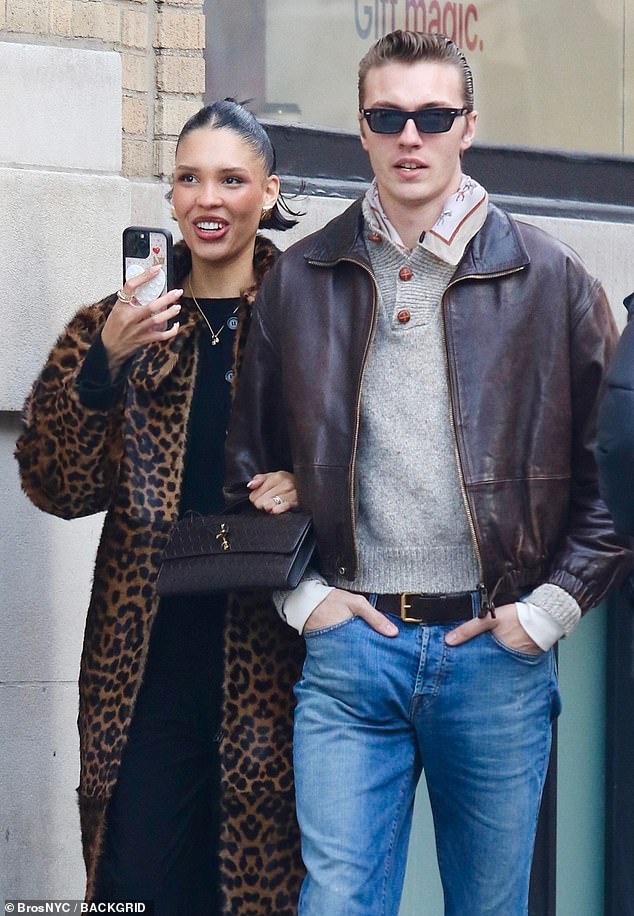 The 23-year-old influencer looked red carpet-ready in a chic leopard-print fur coat over a black cardigan and pants while holding a designer bag.