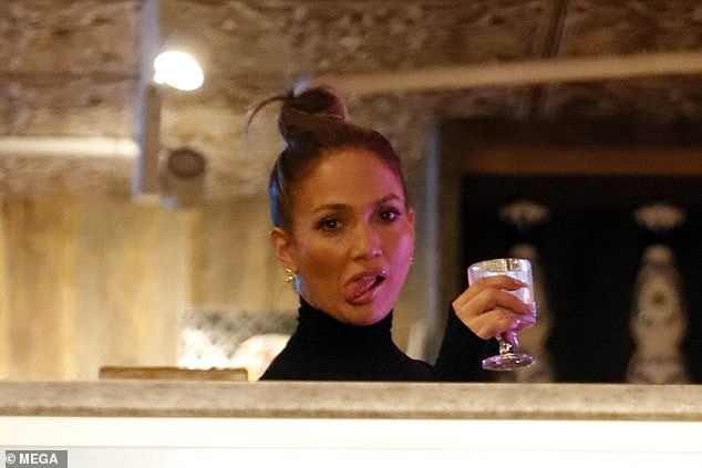 Jennifer is seen making a face while relaxing with a drink