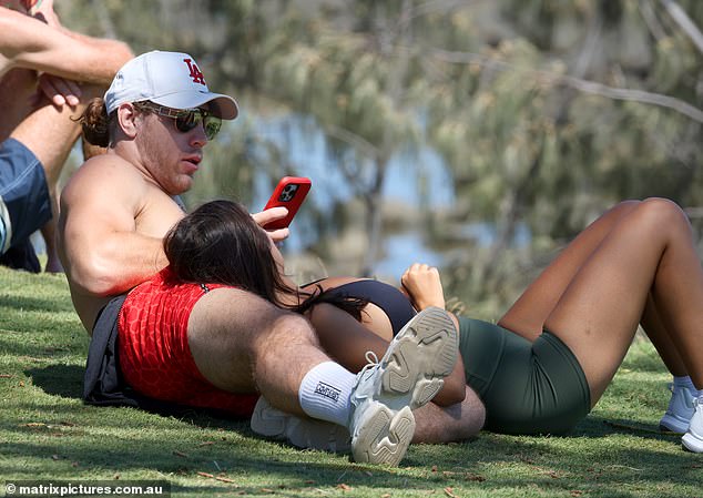 Jayden was seen reclining on the floor while his mystery woman also reclined on his lap.