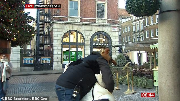 Carol was presenting the weather report in London when what appeared to be a passer-by appeared on camera dressed in a coat and Christmas hat and pulled the star in for a kiss.