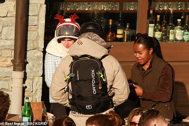 Harry Potter star Emma Watson rocks reindeer antlers while skiing with friends on a Christmas holiday in the Alps.