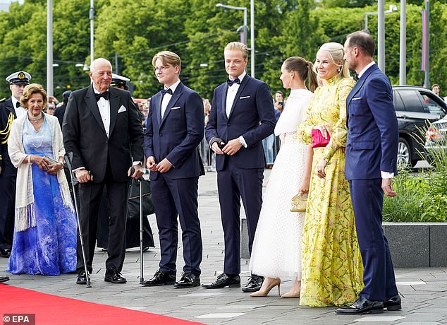 Pictured from left to right: Queen Sonja, King Harold, Prince Sverre Magnus, Princess Ingrid Alexandra, Marius Borg Hoib, in white, Crown Princess Mette-Marit and Prince Haakon.