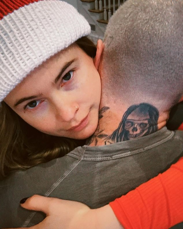 One of the most charming photos showed Behati wearing a Santa hat, her arms around Adam's neck, with the caption 