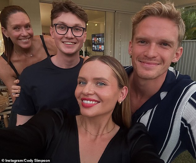 Cody looked dapper in a black and white striped shirt while his double sister Alli, 26, opted for a bold red lip.