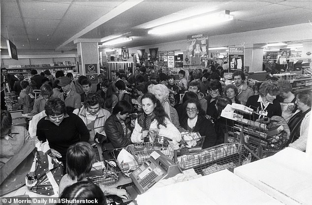 Fascinating images unearthed from the 1990s and 1980s show the last-minute Christmas shopping rush. Pictured: Bargain hunters at Woolworths in Holyhead