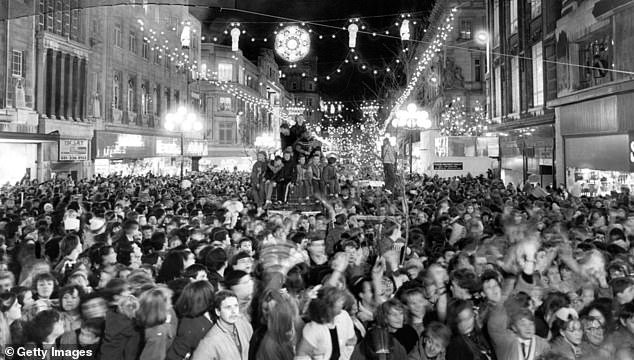 Thousands of people watch the switching on of the Christmas lights on Church Street, Liverpool in 1986