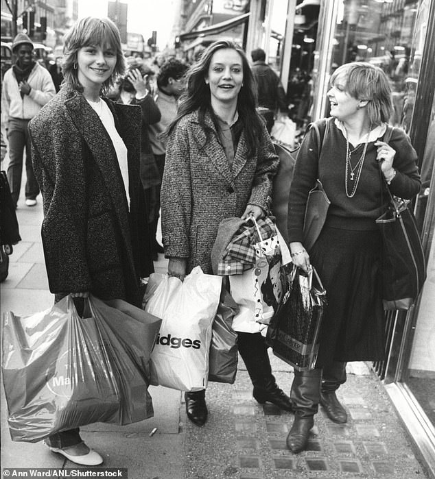 Shoppers on Oxford Street in 1983 with bags full of clothes and Christmas shopping