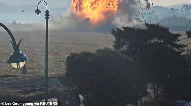 Jeju Air Flight 7C2216 is engulfed in flames when it crashes into a wall following a crash after landing at Muan International Airport in Muan, South Korea.