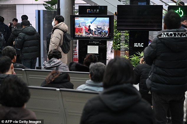 People and families of passengers of the crashed Jeju Air Boeing 737-800 plane react at Muan International Airport in South Jeolla Province