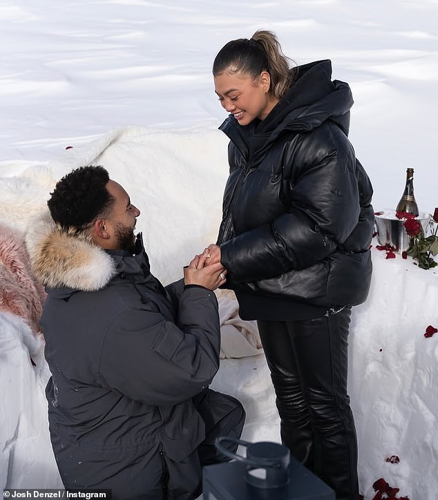 Wrapped in large coats to protect themselves from the cold, the couple was in a private setting surrounded by red roses, champagne and candles.