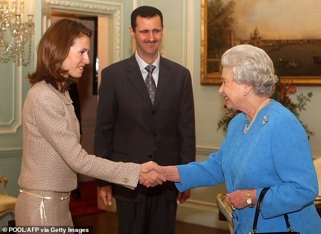 Queen Elizabeth II receives Asma al-Assad and her husband, then Syrian President Bashar Al-Assad, at Buckingham Palace in London on December 17, 2002 during their first visit to Britain