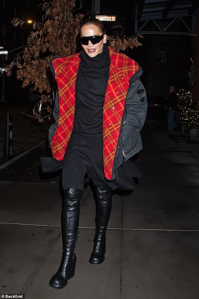 The singer, 34, was seen wearing a striking black puffer coat that featured a red plaid lining as she headed to Times Square, where she will co-host Dick Clark's New Year's Rockin' Eve with Ryan Seacrest.