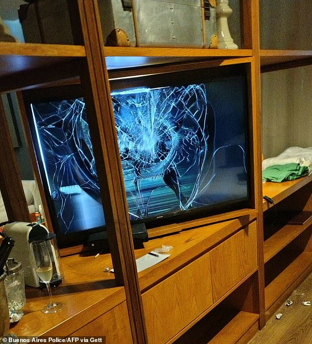 Photo released by the Buenos Aires Police that shows a television with a broken screen and a half-full glass of champagne in the hotel room