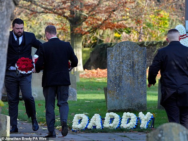 Funeral directors place a floral tribute that reads "Dad" Outside the funeral of One Direction singer Liam Payne.