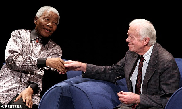 Former South African President Nelson Mandela and Carter shake hands during a ceremony for Mandela's birthday in 2007 (photo)