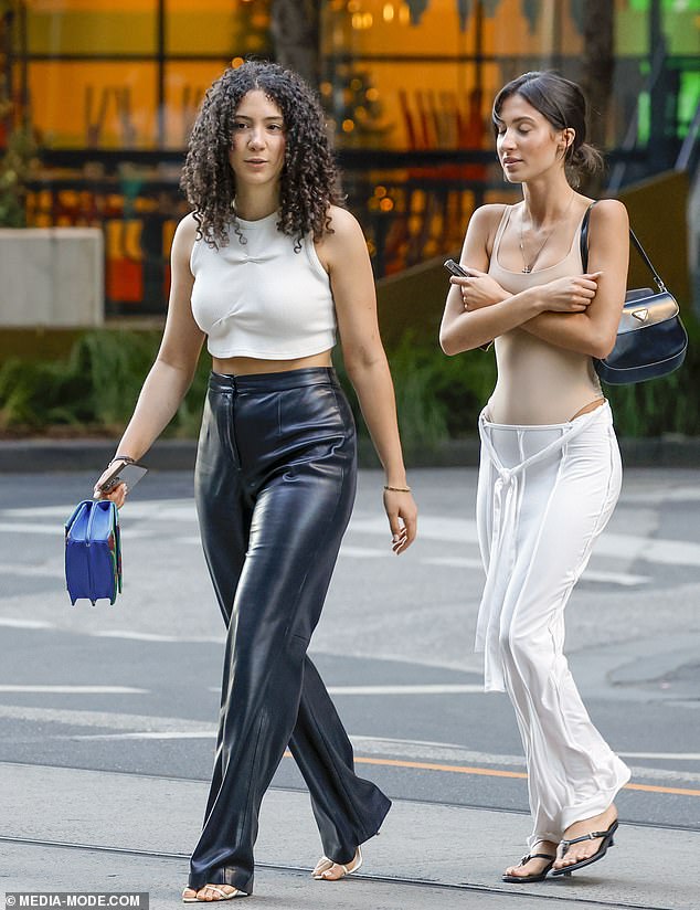 She finished her look with a long white skirt that featured a bow in the front and black heels.