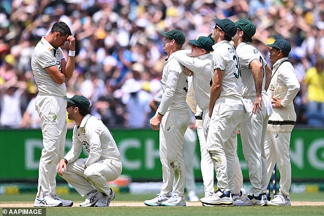 Pictured: Starc (left) and his teammates are surprised when Jaiswal is allowed to remain in the box during the tense chase in India.