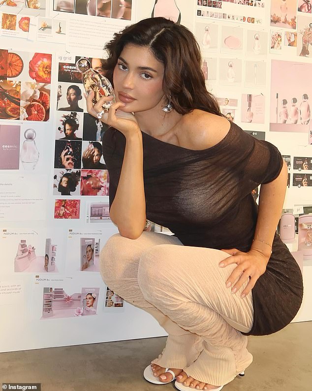 The beauty mogul shared a sexy photo of herself bending over in a sheer shirt while showing off her first fragrance, Cosmic.