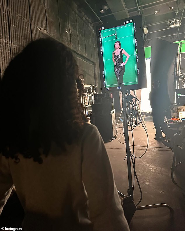 She wrapped the carousel with a behind-the-scenes photo of herself wearing a black sequin dress while on a set.