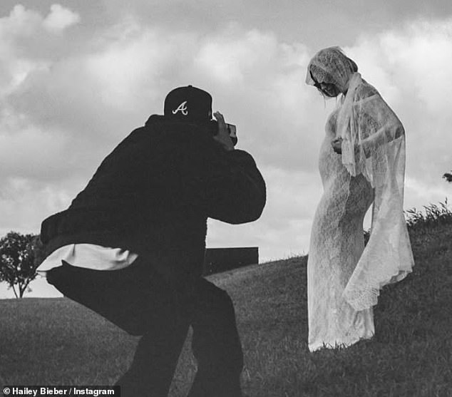 In her post, Hailey, 28, wore a long white lace dress by Saint Laurent and a veil as they paired the announcement with a vow renewal in Hawaii.