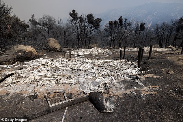 Pictured: The ruins of a burned structure are seen the day after the Bridge Fire exploded from 2,995 acres to 46,727 acres in a single day in September 2024.