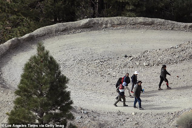 Pictured: Hikers climb a trail leading to Mount Baldy Ski Resort on December 14, 2024.