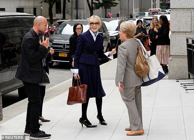 The writer, who wore a dark blazer and suit with a navy blue hair ribbon, did not speak to reporters after the arguments ended