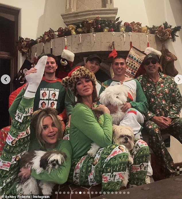 Ashley then shared a heartwarming holiday photo of her and her family, all dressed in matching green Elf pajamas as they gathered by the fireplace.