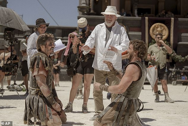 This image provided by Paramount Pictures shows Pedro Pascal, from left, director Ridley Scott and Paul Mescal on the set of Gladiator 2.