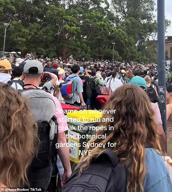 14238041 Chaotic moment: Massive crowds ignore New Year's Eve rules and rush to Sydney's best vantage points before fireworks