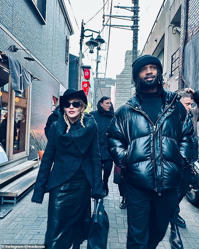 Madonna also shared a candid photo of her and her taller, younger boyfriend walking beside her as they strolled through the picturesque alleys with their crew.