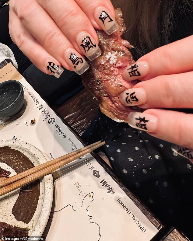 She also posted a photo of her kanji manicure while picking up some food with her bare hands.