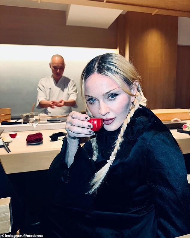 During her trip, Madonna also enjoyed an omekase meal, as seen in photos of her posing with a cup of sake and with a sushi chef preparing her meal behind her.