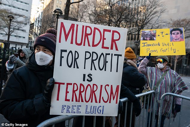 Protesters held signs outside Manhattan Criminal Court calling for Mangione's freedom.