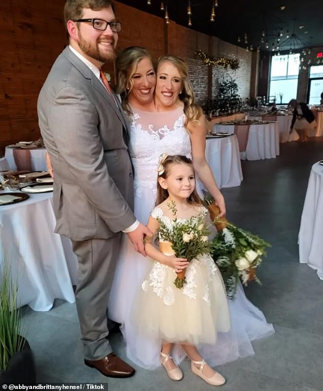 They both currently teach fourth and fifth grades at a local elementary school, where they share the same salary because they teach the same classes. Pictured with Abby's husband, Josh Bowling.