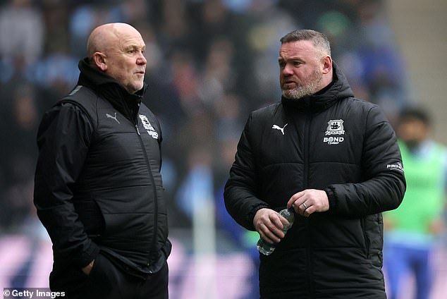 Mike Phelan, left, recently joined as Rooney's assistant in a bid to improve the club's form.