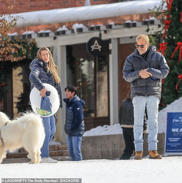 Both Kevin and the woman were dressed for the cold temperatures in the ski town: black puffer jackets, jeans and sunglasses