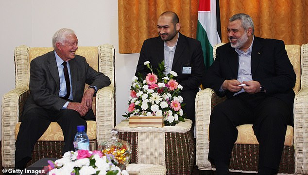 Carter is seen here with then-head of the Hamas government Ismail Haniyeh (far right) during a diplomatic visit to the Gaza Strip in 2009. Jennings framed trips as Carter's 