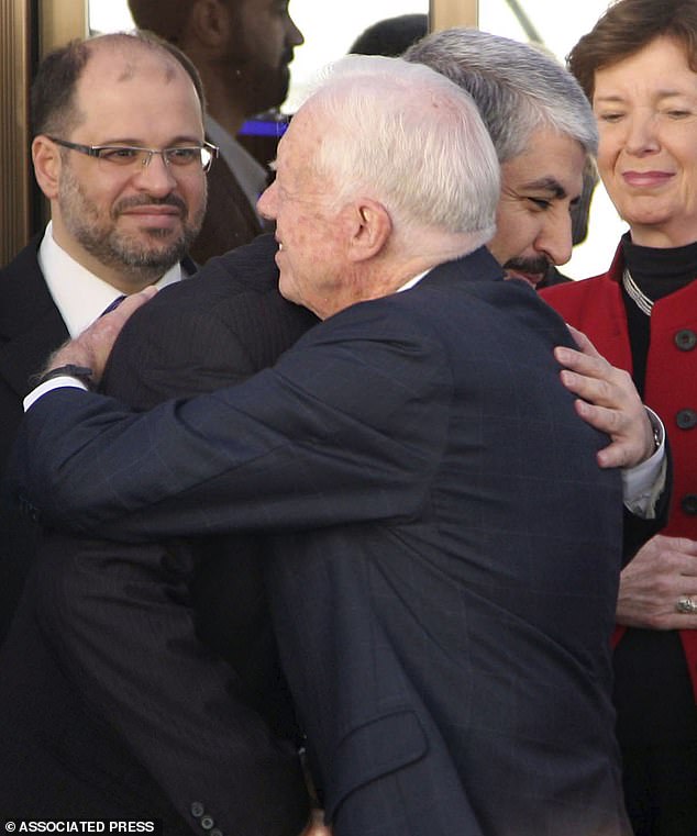 Hamas leader Khaled Mashaal, left, embraces Carter as former Irish President Mary Robinson, right, looks on during another diplomatic trip to Damascus, Syria, in 2010, after meeting with then-Syrian dictator Bashar Assad