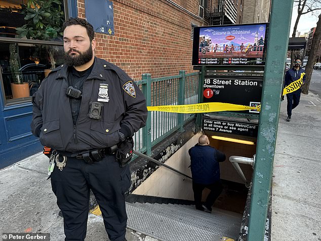 An NYPD officer stands guard after the subway shut down on 18th Street in Manhattan