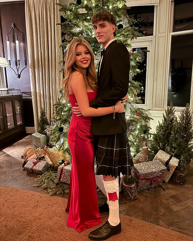 The couple's eldest daughter Lexi wowed in a glamorous red satin sundress as she posed with her boyfriend, who was wearing a kilt.