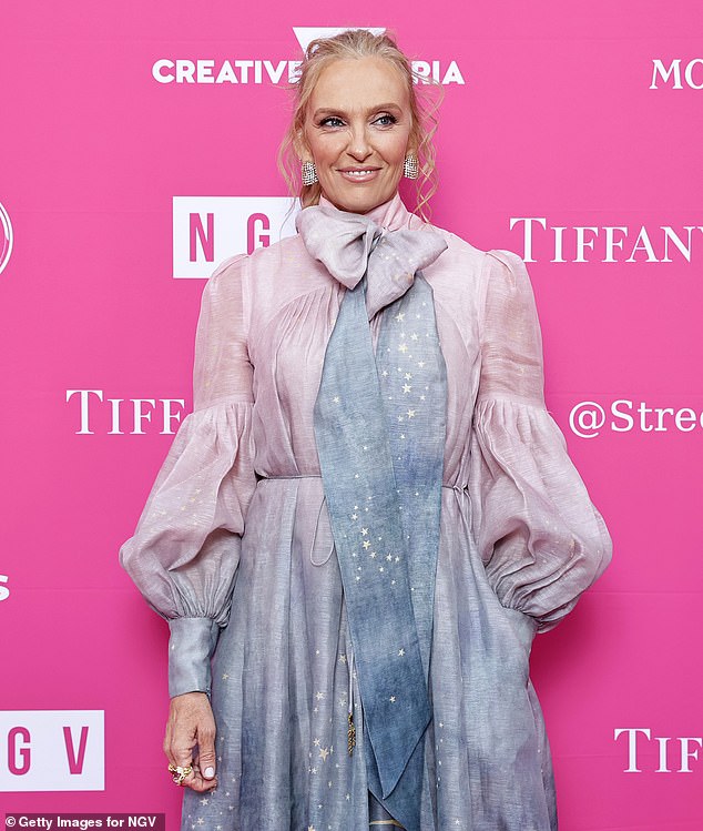 She opted for an artistic, couture dress in shades of muted blue, pink and lilac with a dyed skirt. It included a bow at the neck with flowing tufts and some sparkly details.