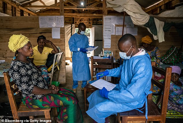 Pictured above is a doctor talking to a patient about treating monkeypox in the South Kivu region in September this year.