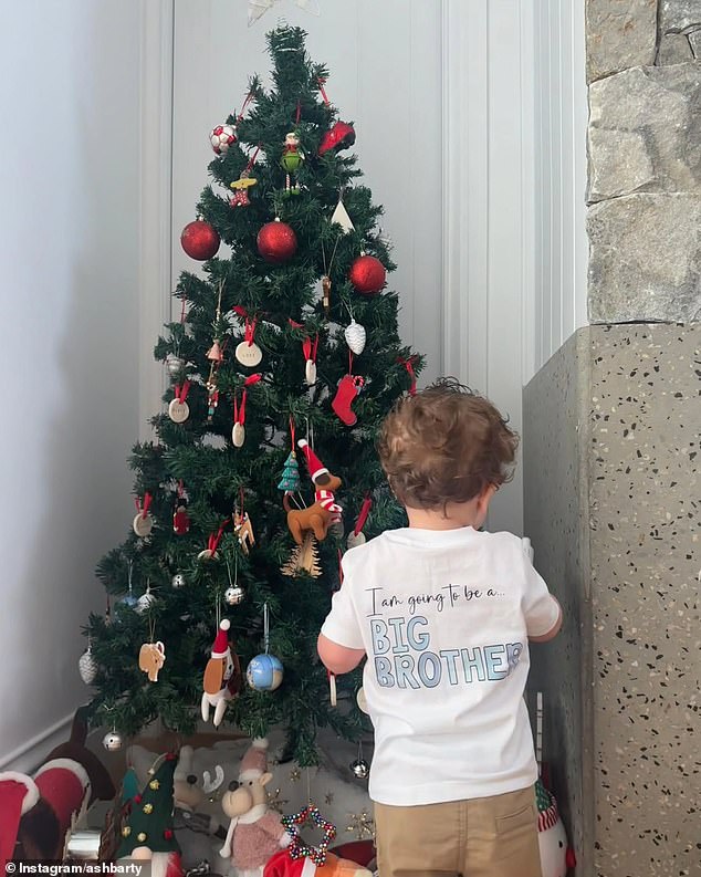 On Instagram on Christmas Day, Barty posted a sweet photo of her 17-month-old son Hayden standing in front of their Christmas tree wearing a T-shirt with some revealing words on it.