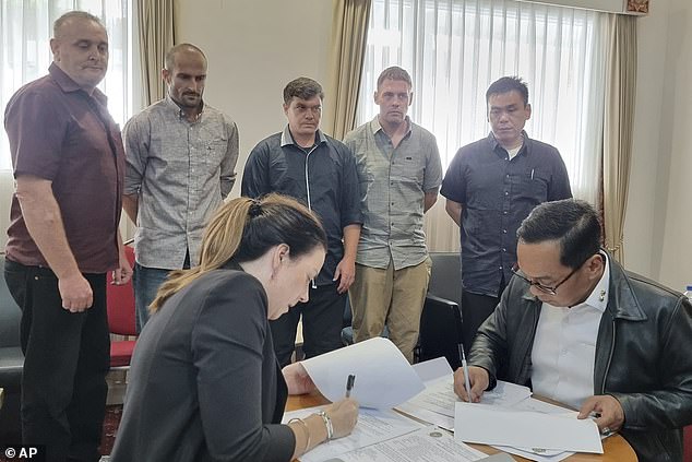 The five freed Bali Nine conspirators, from left: Martin Stephens, Michael Czugaj, Scott Rush, Matthew Norman and Siu Yi Chen watch as their releases are approved by Australian and Indonesian officials.