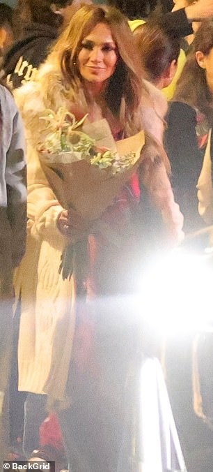 López appears in the photo with a bouquet in her hand for Emme